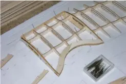  ??  ?? The top wing center section is built up directly over the plans. The trailing edge cutout is laminated from balsa to ensure a smooth transition when covered. The outer wing panels are framed up beginning with the rib and spar assemblies aligned over the plans and glued in place.