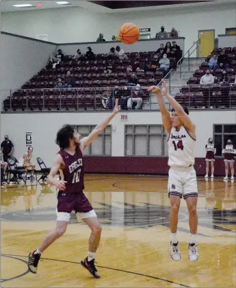  ?? Graham Thomas/Siloam Sunday ?? Siloam Springs senior Landon Ward, No. 14, shoots a 3-pointer in the first half against Huntsville on Friday. Ward scored 17 of his game-high 23 points in the second half of the Panthers’ 57-34 victory.