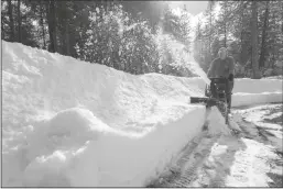  ?? PAUL KITAGAKI JR/SACRAMENTO BEE ?? Kim Glasso uses a snow blower to clear the sidewalk around his home in Dutch Flat on Tuesday. The Sierra foothills has been hit hard with snow, leaving thousands without power for days in Nevada County.