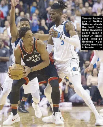  ?? AP ?? Toronto Raptors guard DeMar DeRozan shields the ball from Dallas Mavericks guard Dennis Smith Jr. (back) and center Nerlens Noel during overtime in Toronto.