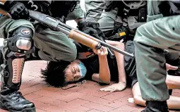  ?? ISAAC LAWRENCE/GETTY-AFP ?? Police arrest pro-democracy protesters Sunday in the Causeway Bay district of Hong Kong. At least 180 protesters were arrested, mostly on charges of unlawful assembly.