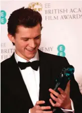  ??  ?? Actor Tom Holland poses with his BAFTA award for Rising Star.