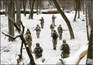  ?? EFREM LUKATSKY / AP ?? Ukraine’s Territoria­l Defense Forces, volunteer military units of the Armed Forces, train in a city park Saturday in Kyiv. Dozens of civilians have been joining Ukraine’s army reserves in recent weeks.