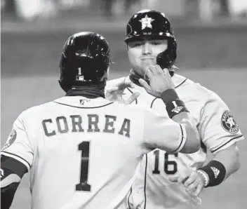  ?? HARRY HOW GETTY IMAGES ?? Houston’s Aledmys Diaz and Carlos Correa celebrate their runs on a Josh Reddick double in the ninth.