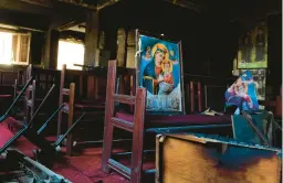  ?? TAREKWAJEH/AP ?? Charred furniture and religious imagery are visible after a deadly fire inside the Abu Sefein Coptic church in the densely populated neighborho­od of Imbaba in Cairo.