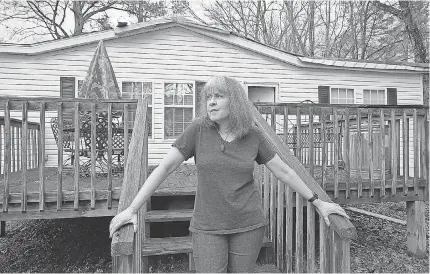  ?? BOB FARLEY/ FOR USA TODAY ?? Kathleen Immel Cross stands in front of her home in Pinson, Ala. She is saving up money to put on a tin roof on her storm- damaged house.