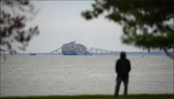  ?? Matt Rourke/Associated Press ?? A view of the collapsed Francis Scott Key Bridge and the container ship that struck it, from Fort McHenry in Baltimore late last month. Six people died when the bridge fell.