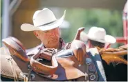  ?? GABRIELA CAMPOS/THE NEW MEXICAN ?? Rick Spillhaus prepares to take off the saddle of T4, a quarter horse, after his training to become an instructor for Horses For Heroes at Crossed Arrows Ranch south of Santa Fe. The program offers free horsemansh­ip lessons to all post-9/11 combat veterans and active duty military personnel.