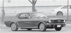  ?? AP Photo/Carlos Osorio ?? ■ A 1964 Ford Mustang is driven outside the Flat Rock Assembly plant Wednesday in Flat Rock, Mich.