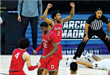  ?? Associated Press ?? ■ Ohio State’s Duane Washington Jr., left, E.J. Liddell, center, and Musa Jallow celebrate after a 68-67 win over Michigan on Saturday during the Big Ten Conference tournament in Indianapol­is.