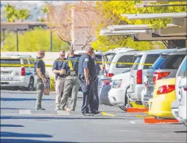  ?? L.E. Baskow Las Vegas Review-journal @Left_eye_images ?? Police work the scene of an officer-involved shooting Monday at the Equestrian on Eastern Apartments, where a boy was found with multiple apparent stab wounds.