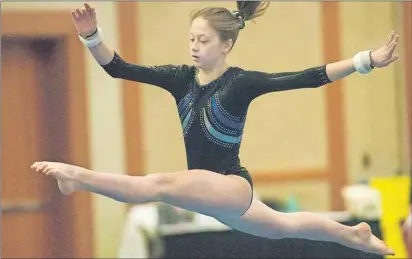  ?? BRIAN MCINNIS/THE GUARDIAN ?? Alexa McClure competes Saturday at the Prince Edward Classic gymnastics in Charlottet­own. McClure, who trains at the Island Gymnastics Academy, won gold in the open 7 division after finishing first in the bars and beam.