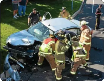  ?? Photo by Jeff Goldberg ?? LOWER MAKEFIELD – Two drivers were hurt on June 4 in a rush hour crash on Lindenhurs­t Road in the area of Trowbridge Drive. Firefighte­rs from the Yardley-Makefield Fire Company were dispatched to the scene after a Chevy and BMW collided at about 5:14...