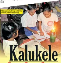  ??  ?? Children studying with the help of a kerosene lamp