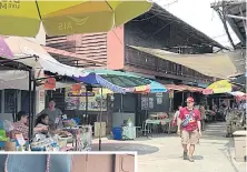  ??  ?? Ratanathor­n Kaonongbua, left, president of Khanom Plaek Community Enterprise, is happy to see the success of his idea to promote his hometown as a tourist attraction. He said the weekend market can generate up to 2 million baht a month for local...