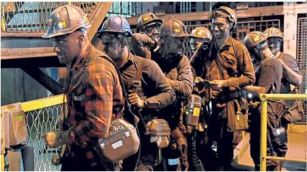  ?? — AFP ?? Hard day’s work: Miners leaving the shaft at the Knurow mine after a night shift in Knurow, Poland’s southern mining region of Silesia