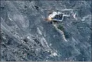  ??  ?? Disaster: a rescue helicopter passes debris from the Germanwing­s jet in the French Alps. Left, co-pilot Andreas Lubitz