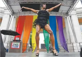 ?? Photos by Andy Cross, The Denver Post ?? Zarah, one of many performers at Denver Pridefest, fires up the crowd Saturday. The event continues Sunday with a worship service, a parade and more.