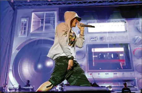  ?? AKILI- CASUNDRIA RAMSESS FOR THE AJC 2014 ?? The tense, creeping beat of “LoseYourse­lf” ismotivati­ng enough, butwhen Eminem, seen playingPie­dmontPark in 2014, starts firing lyrics about “one opportunit­y to seize everything you everwanted,” it’s enough tomake even a spectator eating a pretzel feel invincible.