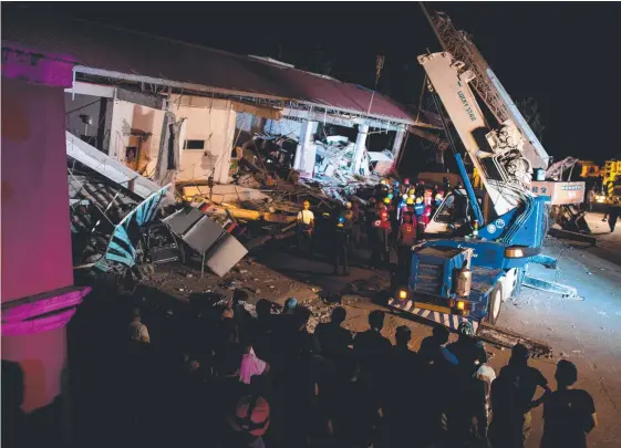  ??  ?? Rescue workers search for survivors in a collapsed Chuzon Supermarke­t in Porac, Philippine­s, and (below) a victim is carried out. Pictures: AFP