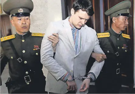  ??  ?? American student Otto Warmbier is escorted at the Supreme Court in North Korea in 2016. JON CHOL JIN/AP