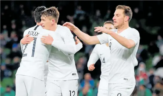  ?? Photo / Photosport ?? Callum McCowatt (centre) celebrates scoring on his debut to give the All Whites the lead against Ireland yesterday.