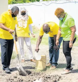  ?? PHOTOBYAND­RÉHESLOP ?? ESL officers Felix Whyte and Ian Gage engage in a recent tree-planting effort while EleanorJon­esandRashi­dahKhan-Haqqlookon.