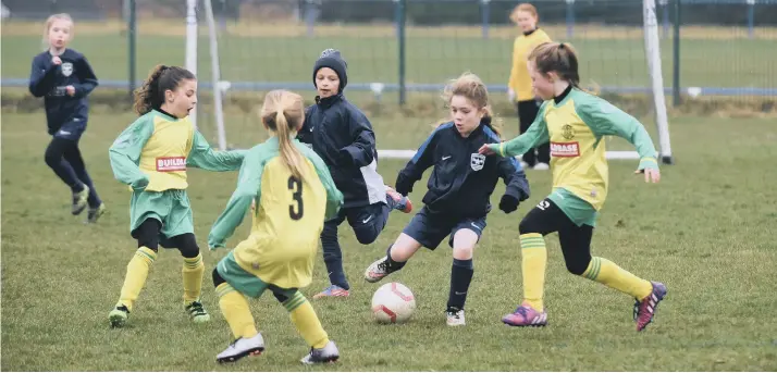  ??  ?? Washington AFC Girls U9s (blue) take on Leam Rangers (green/yellow) at East Durham and Houghall College in Peterlee