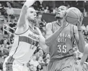  ?? Rob Carr / Getty Images ?? Kevin Durant, right, was on his way to an outstandin­g game with 14 points in the first half before departing with an injured hamstring.