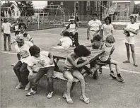  ?? Times Union archive ?? Students in 1977 play a game around a picnic table in Watervliet's Brotherhoo­d Park.