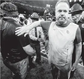  ?? Brett Duke / Associated Press ?? Baylor coach Matt Rhule walks away after greeting Georgia coach Kirby Smart following the Bears’ 26-14 loss at the Sugar Bowl late on Wednesday night.