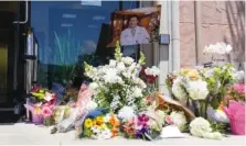  ?? AP PHOTO/ASHLEY LANDIS ?? A memorial honoring Dr. John Cheng sits outside his office building on Tuesday in Aliso Viejo, Calif. Cheng, 52, was killed in Sunday’s shooting at Geneva Presbyteri­an Church.