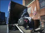  ?? NANCY LANE — BOSTON HERALD ?? Boston, MA - Workers load a moving van during Red Sox Truck Day at Fenway Park.
