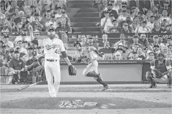  ?? Michael Ciaglo / Houston Chronicle ?? The Astros’ Jose Altuve begins his trot around the bases after homering in the 10th inning of Game 2 of the World Series at Dodger Stadium on Wednesday night.