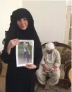  ??  ?? Tatiana Kruzina with a picture of Athan. Behind is the father, Majid Janjua