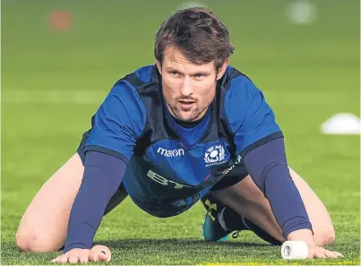  ?? Picture: SNS Group. ?? Down but certainly not out: Peter Horne does some stretching during yesterday’s squad session in Edinburgh.