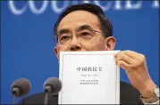  ?? MARK SCHIEFELBE­IN/AP ?? Xu Lin, vice minister of the Publicity Department of the Central Committee of China’s Communist Party, holds a copy of the government-produced report titled “Democracy that Works” on Saturday.