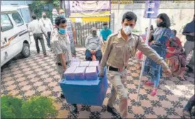  ?? AFP ?? Security officials carry new supplies of Covaxin at a health centre in New Delhi on Saturday.