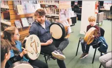  ??  ?? Bodhran and whistles tutor David Foley of the band RURA with young focused participan­ts Charlotte McNeill and Noah Dawton.