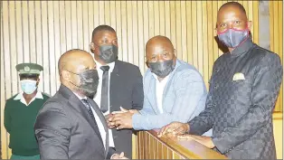  ?? (File pics) ?? Hosea MP Mduduzi Bacede Mabuza (R) and his co-accused Ngwempisi MP Advocate Jacobus Lodewicus Coetzee Jansen Van Vuuren (L) registers his shock to the MPs after the delivery Mthandeni Dube (2nd R) looking at their supporters before having a moment of the judgment on Tuesday. (R) The MPs engaging their defence team. with Sicelo Mngomezulu (L), who forms part of their defence team.
