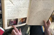  ??  ?? Ryan Cooper displays pages from a 1973 portion of a diary, which he wrote when he visited Otto Frank.