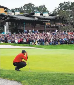  ?? K.C. ALFRED U-T ?? Tiger Woods, shown lining up putt during the Farmers Insurance Open last year at Torrey Pines South, attracts far larger galleries than any other player.