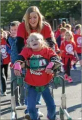  ??  ?? French Creek Elementary School secondgrad­e student, Lily Ciechoski and teachers aide, Cassie Dollard take part in the school’s walk-a-thon on Oct. 18th. Every grade took part in the program.