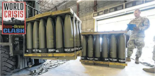  ?? (Photo: AP) ?? US Air Force Staff Sgt. Cody Brown, right, with the 436th Aerial Port Squadron, checks pallets of 155 mm shells ultimately bound for Ukraine, Friday, April 29, 2022 at Dover Air Force Base, Delaware