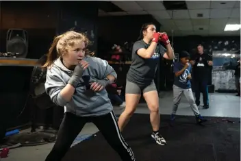  ?? PHOTOS BY KELSI BRINKMEYER ?? Above: Boxing student Makenzie May, left, practices with her classmates during a session at Texarkana Boxing Academy.
Makenzie spars at Texarkana Boxing Academy. The class was led by coach Courtney Pitts.
Opposite: