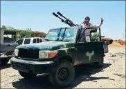  ?? XINHUA ?? A Syrian soldier makes a victory gesture in a vehicle in Daraa,
Syria, on Friday.