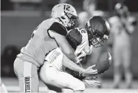  ?? JONATHON GRUENKE/STAFF ?? Warhill’s Chase Barnett tackles Poquoson’s Jaxson Weissman to force a fumble during Thursday night’s game.