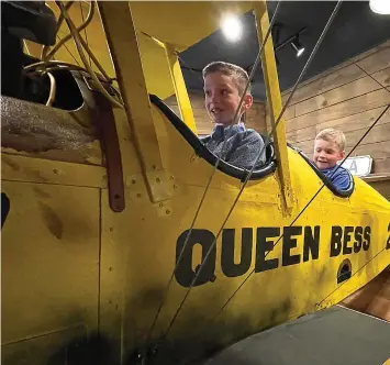  ?? (Photo by Neil Abeles) ?? There may be no better airplane to fly than this one named Queen Bess in the Atlanta Museum, shown at left. Cannon McDaniel, left, of New Boston and his brother Connor are the flyers.