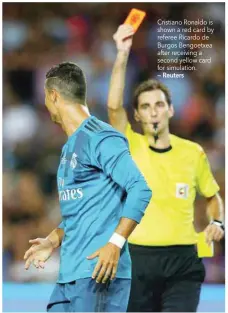  ?? — Reuters ?? Cristiano Ronaldo is shown a red card by referee Ricardo de Burgos Bengoetxea after receiving a second yellow card for simulation.