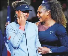  ?? USA TODAY Sports ?? Osaka wipes her tears as Serena Williams comforts her during the presentati­on ceremony.